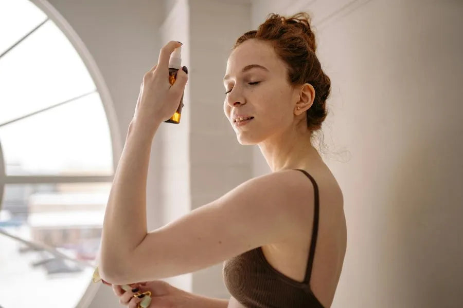 woman applying facial mist