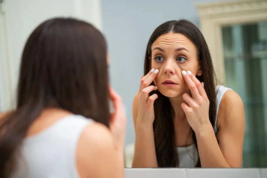 woman looking at her eye bags