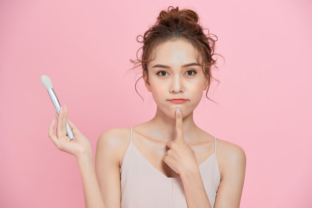 a lady holding a brush