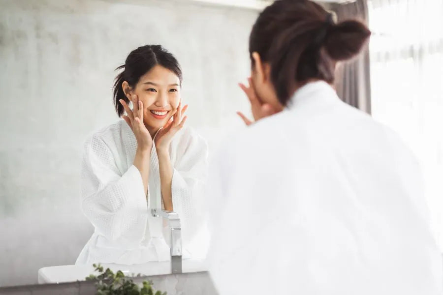 woman applying facial serum