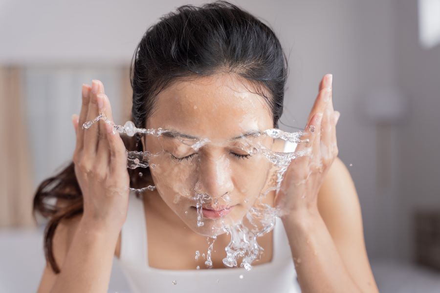 woman washing her face